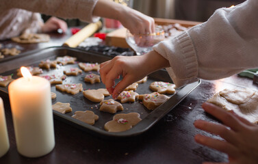 Merry Christmas and happy holidays. Family cooking of festive food. Two little girls cook cookies in a New Year's interior with a Christmas tree.