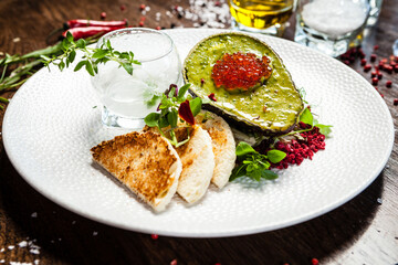 Tuna tartare. Trout roe, avocado cream, marinated onions. Delicious healthy Italian traditional food closeup served for lunch in modern gourmet cuisine restaurant