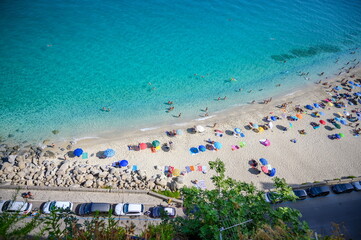 View of the famous beach with colourful umbrellas in Tropea (Cal