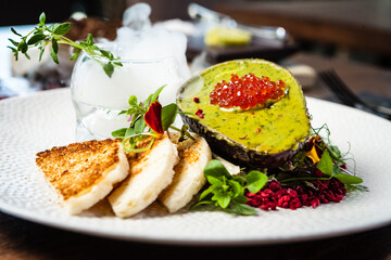 Tuna tartare. Trout roe, avocado cream, marinated onions. Delicious healthy Italian traditional food closeup served for lunch in modern gourmet cuisine restaurant