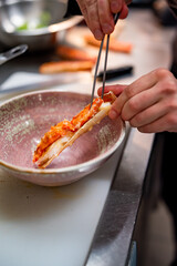 Close up hand of chef in restaurant cooking crab leg
