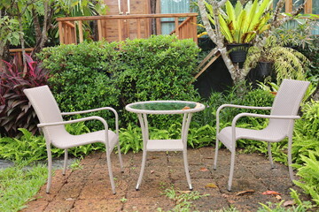 Chairs and white table in the garden in front of the house