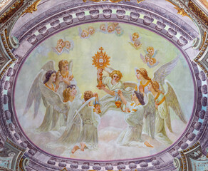 MORGEX, ITALY - JULY 14, 2018: The ceiling fresco of Eucharistic adoration of angels in church Chiesa di Santa Maria Assunta E. Lancia (1932).