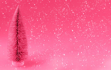 Artificial Christmas tree on a magenta background with snow. Banner