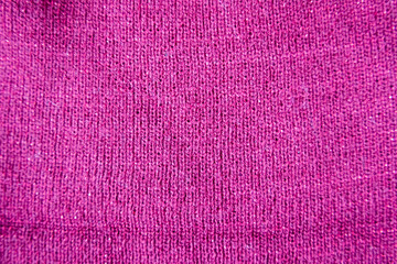 Pink linen texture for the background. Bright redviolet knitted texture
