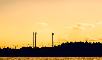 Fototapeta premium Communication Towers with electric pole, silhouette scene