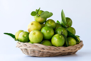 Fresh green oranges in basket , Fresh green oranges at market and shop for sell..Fresh green lemons, in basket , Fresh green lemons at market and shop for sell.