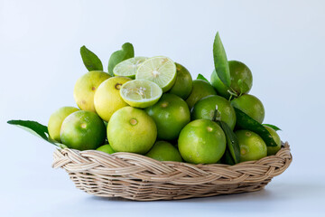 Green lemon in rattan basket for sell at market and supermarket.