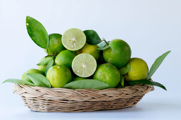 Green lemon in rattan basket for sell at market and supermarket.