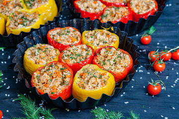 Stuffed pepper. Stewed pepper  with rice and minced meat. Baked peppers in a cast iron pan on a black background. Healthy Romanian food.