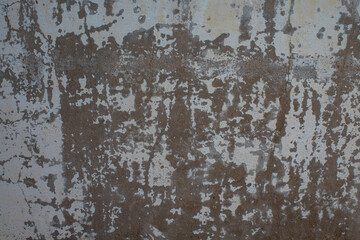Weathered white wall with peeling paint giving the impression of abandonment