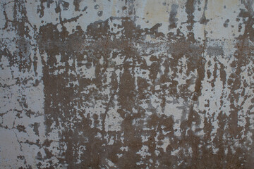Weathered white wall with peeling paint giving the impression of abandonment