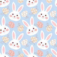 Seamless pattern with bunny faces and eggs on blue background.
