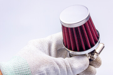 Conical chrome air filter with  - tuning accessory on a gray background