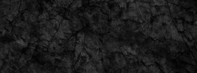 Ancient and grainy Black Emperador marble texture with various cracks, dusty and cracked old wall texture, dark black and grainy Concrete floor or old grunge, old blackboard or chalkboard texture.	