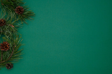 Christmas, new year composition. Layout of pine branches and cones on a green background.Flat lay