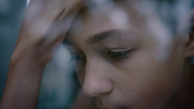 sad teenager boy near the window, regrets what he did, misses someone, steadicam cinematic shot
