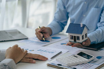 Real estate agent and client discussing home purchase agreement Insurance or real estate loan...