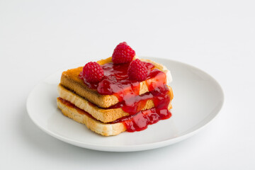 Toast bread with raspberry jam on plate