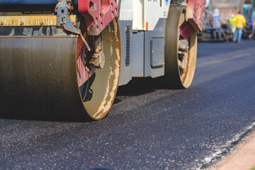 Machinery or heavy rollers in construction of new asphalt roads. working on new asphalt road At the construction site of a new paved road