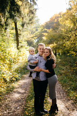 Fototapeta premium happy family playing and laughing in autumn park