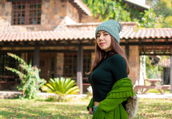 Mujer bonita caucasica y joven volteando a la camara con ropa de invierno y sonriendo en una...