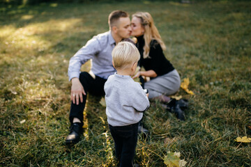 Fototapeta premium happy family playing and laughing in autumn park