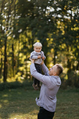 Fototapeta premium happy family playing and laughing in autumn park