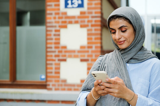 Middle-aged woman using smartphone while standing outdoors