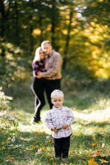 Fototapeta premium happy family playing and laughing in autumn park