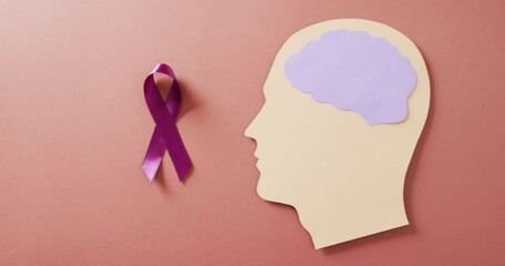Video of purple add or adhd awareness ribbon and head with purple brain, on brown with copy space