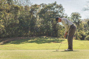 Man playing golf on a golf course..