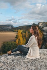 Beautiful girl posing in nature. Autumn photo session in nature.