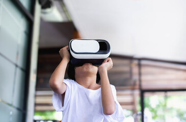 Young girl kid child play virtual reality game hold vr glasses and surprised. Cyber space and virtual gaming