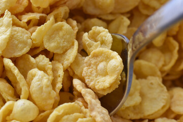 Cornflakes on spoon.  Cereal background.  Healthy breakfast concept. 