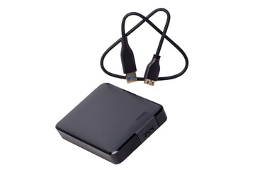 A external hard drive from large capacity and a USB cable for connected to laptop for backing up files and important information isolated on white. Portable hard drives for data backup. Macro.