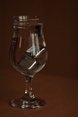 Glass of water with steel ice cubes