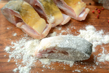 Fresh, raw carp fish slices breaded in flour. Preparing fish for frying. Traditional Polish...