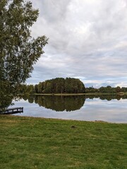 picturesque lake view with small bridge and reflections