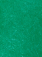 Abstract elegant, detailed dark green glitter particles flow with shallow depth of field underwater. Holiday magic shimmering luxury background. Festive sparkles and lights. de-focused.