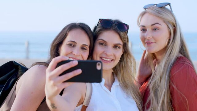 Women, phone and beach selfie for social media, travel vlog or memory of holiday, vacation and outdoor freedom together. Happy group of people, friends and girls taking mobile photograph on promenade