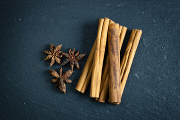 cinnamon sticks and star anise on a black background
