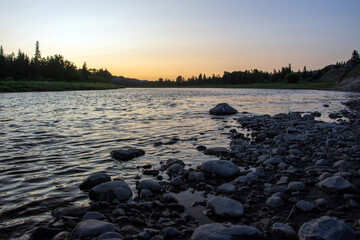 Sunset over rocks on bank of Red Deer River, Alberta