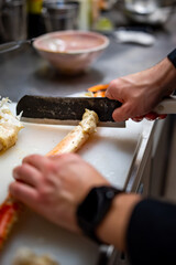 Close up hand of chef in restaurant cut the crab leg