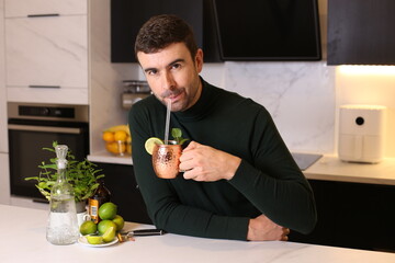 Man preparing a Moscow mule cocktail in copper cup 