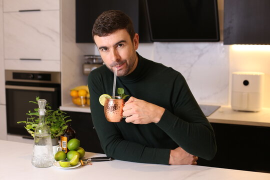 Man preparing a Moscow mule cocktail in copper cup 