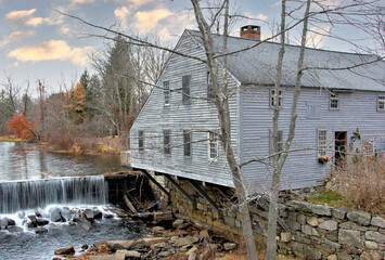 Rural New England scene. Squannacook River dam that once supplied power for this historic sawmill and cooperage in Townsend, Massachusetts. - obrazy, fototapety, plakaty