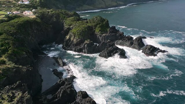 Stationary aerial view of a scenic coastline with volcanic rock in S&atilde;o Jorge, Azores