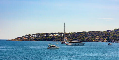 Panoramic view of harbor and exclusive residential peninsula along Plage del la Salis beach onshore...