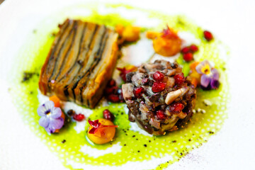 Shiitake and potatoes (vegan). Shiitake mushroom, potato gratin, Beluga lentils, yellow beet cream. Delicious healthy traditional food closeup served for lunch in modern gourmet cuisine restaurant